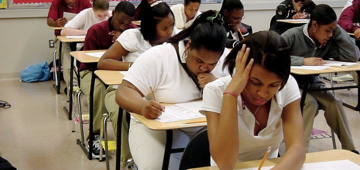 Students in classroom doing classwork Students in classroom doing classwork